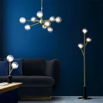 Satin brass glass pendant light in multi arm design with matching table lamp and floor lamp.
