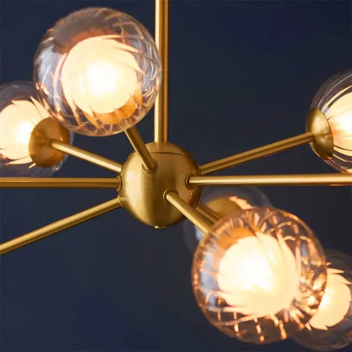 Satin brass glass pendant light in multi arm design.