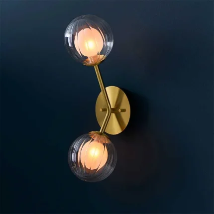 Wall light in satin brass finish with clear ribbed glass