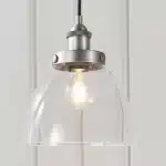 Single pendant light in brushed silver finish with clear glass shade