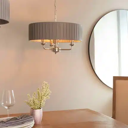 Multi arm bright nickel pendant light above dining table