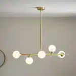 Satin brass linear pendant light with gloss opal glass shades lifestyle