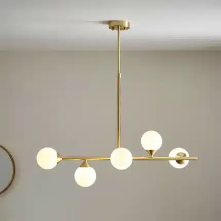 Satin brass linear pendant light with gloss opal glass shades lifestyle