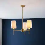 Satin brass pendant light with vintage white shades lifestyle