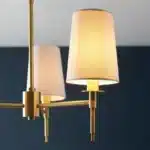 Satin brass pendant light with vintage white shades side angle