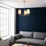 Satin brass pendant light with vintage white shades in living room