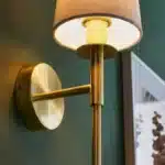 Satin brass wall light with vintage white fabric shade bulbholder view