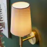 Satin brass wall light with vintage white fabric shade top angle