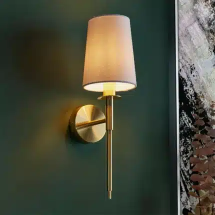 Satin brass wall light with vintage white fabric shade lifestyle image